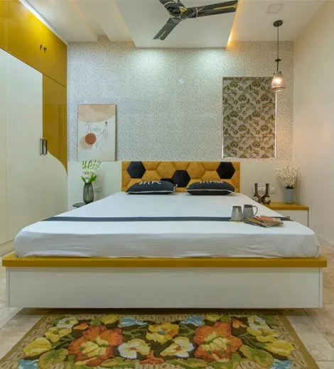 Modern bedroom with custom wardrobe, upholstered headboard and warm ambient lighting